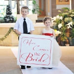 Paying homage to one of the worlds most famed wedding sayings, our "Here Comes the Bride" Banner is a super fun and unique way to announce the brides arrival! Typically carried down the aisle by ring bearers and flower girls right before the bridal march, this ultra enjoyable banner will give all your guests one more reason to turn their heads in excitement! And because each sign can be customized in your choice of one of todays hottest wedding colors, its easy to see why so many brides are saying "I do" to this new trend! Custom banner comes complete with wooden dowel rod and two dowel caps for a truly distinctive, finishing look. Details: Size: Banner measures 27 inches wide by 24 inches long. Dowel rod measures 28 inches long. Materials: Poly canvas and wood