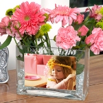 This rectangular vase is constructed of thick clear glass with an inset base. On the broad front of the glass vase is a protective insert for a special photo. Above the photo, you can choose a custom engraved line in a sophisticated block print. Our Glass Photo Vase makes an ideal gift for both men and women. Create a one-of-a-kind gift by inserting a favorite photo and having a special sentiment engraved at the top of the vase. The vase can hold either real or dried flowers, making it a great gift for birthdays, special occasions, holidays, or even just to say thank you! 