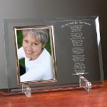 Christmas is a beautiful time of the year to remember a loved one who has passed. Your Personalized Christmas Bereavement Frame displays your loving keepsake photo along side a thoughtful poem honoring your precious loved one. Our Personalized Christmas Bereavement Beveled Glass Picture Frame is a heavy-weight glass with beveled edges on all sides, accented with golden brass frame trim. Personalized Picture Frame measures 8" x 11" and holds your 4" x 6" photo; includes clear easel legs for top display. Includes FREE Personalization! Personalize your Engraved Christmas Memorial Picture Frame with any name and year.