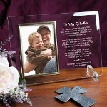 Say Thank You to your Godfather with our attractive Personalized To My Godfather Picture Frame and besure to include your favorite photo of your little angel to complete this Engraved Godfather Keepsake. Our Personalized Godfather Beveled Glass Picture Frame is a heavy-weight glass with beveled edges on all sides, accented with golden brass frame trim. Frame measures 8" x 11" and holds your 4" x 6" photo; includes clear easel legs for top display. Includes FREE Personalization! Personalized with any two line custom message. (i.e. Forever In My Prayers/Love, Logan)