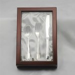 Silver plated knife, fork and spoon set packaged in a beautiful wood display box with a clear glass top. Select a single initial to be engraved on all three pieces for a special keepsake. Personalize with a single initial.