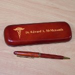 Present your favorite doctor with a personalized doctor gift that is sure to be used every day. A Personalized Doctor Writing Set is an inexpensive doctor gift with an expensive feel. Each Rosewood Personalized Doctor Pen Set makes a unique Doctor gift for him or her. Personalized Pen Set for any doctor is presented with a matching rosewood case for convenient storage and a beautiful gift presentation. Pen measures 6" in length, black ink and features twist action ballpoint operation. The pen can be refilled with a standard Parker refill. The Doctor Pen Case is personalized with any name.