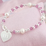 Your little one will absolutely love our Little Girls Heart Charm Bracelet. This delightful bracelet is adorned with sparkling clear and pink crystals, freshwater pearls and sterling silver-plated hardware. With all that dazzle shell be delighted to wear any chance she gets! Includes a free organza gift pouch. Details: Size: Measures 5 1/2 inches. Materials: Crystals, freshwater pearls and sterling silver-plated beading and charm Engraving Options: The Little Girls Heart Charm Bracelet may be engraved with her single initial in a cute lower case letter at No Additional Cost.