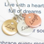 Send an expression of love with the three toned live love laugh necklace. This inspirational gift is sure to be a reminder to live with a heart full of dreams, love from the depth of your soul and to embrace every moment of laughter. Whether giving as a graduation gift, a birthday gift or just as a gift of inspiration, the receiver will be reminded to embrace life. 