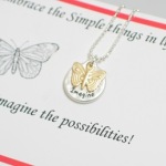 Embrace the simple things in life... Card reads: Imagine the possibilities! silver beaded ball chain with lobster clasp. Matt silver toned "imagine" disc and butterfly charm. Approximately 18" 